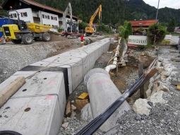 Gerinneausbau Hausbach: mit großem Gerät werden die bis zu 6 Tonnen schweren Fertigteile des Hochwasserentlastungskanals eingehoben